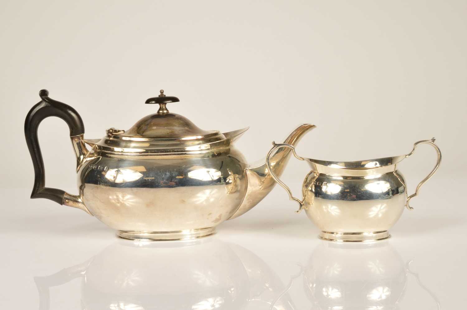 Lot 373 - A George V silver teapot and sugar basin by William Hutton and Sons