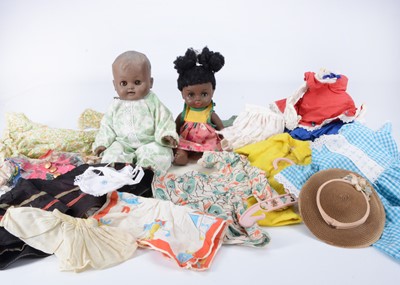 Lot 513 - Two black plastic baby dolls and accessories