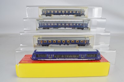 Lot 415 - Roco HO Gauge unboxed Bodensee-Bahn Railcar and three boxed Trix Express Touropa and other blue Coaches (4)
