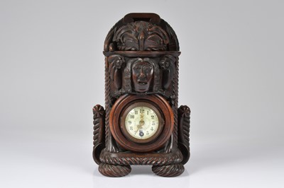 Lot 5 - An interesting late 19th century Black Forest carved wooden mantle clock