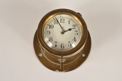 Lot 26 - A small vintage brass bulk head ship's clock