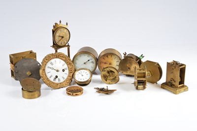 Lot 54 - A collection of small clock movements and other related items