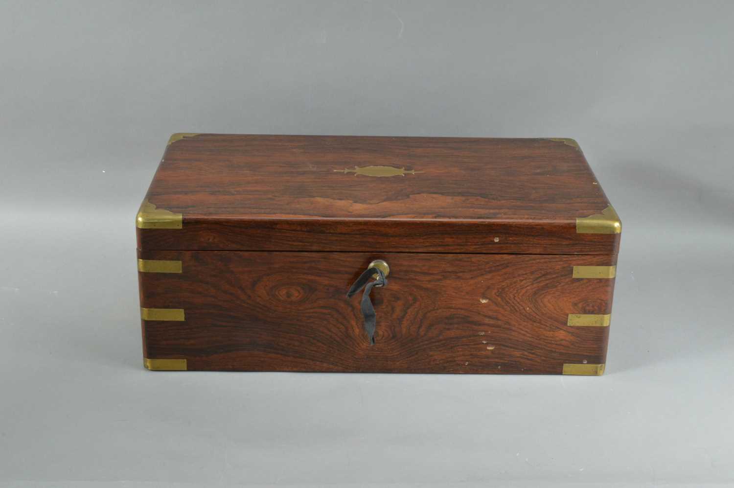 Lot 215 - A 19th century rosewood veneered and brass bounded campaign writing slope