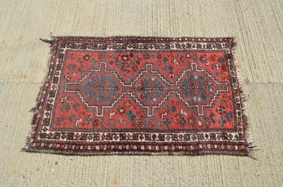 Lot 10 - A small crude woollen rug