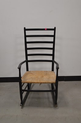 Lot 85 - A 20th century ebonised wooden rocking chair