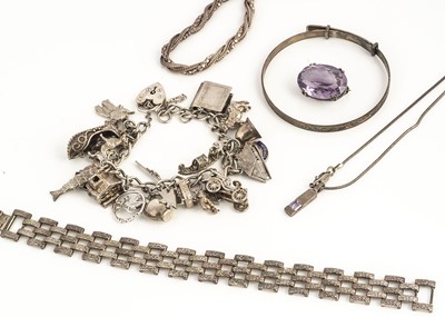 Lot 34 - A curb linked silver charm bracelet