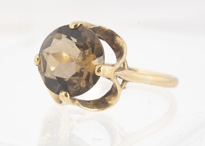 Lot 40 - A yellow metal smoky quartz dress ring