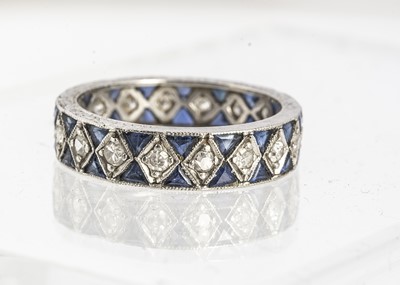 Lot 42 - A white metal sapphire and diamond full eternity ring