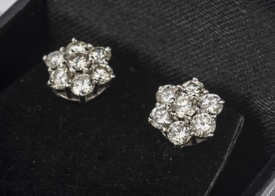 Lot 65 - A pair of diamond white gold flower head ear studs