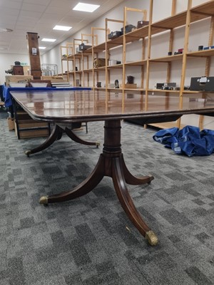 Lot 50 - A late 19th / early 20th century mahogany twin pedestal and brass dinning table