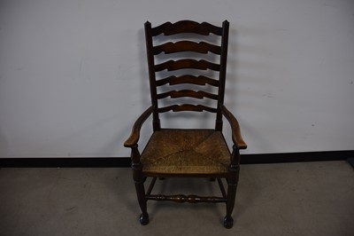 Lot 69 - An antique mixed wood ladder back chair