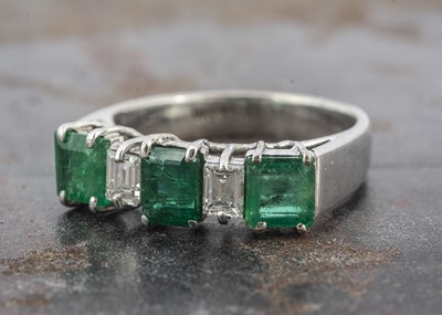 Lot 3 - A white gold emerald and white stone dress ring