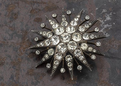 Lot 27 - An early 20th Century silver and paste set twelve point star brooch