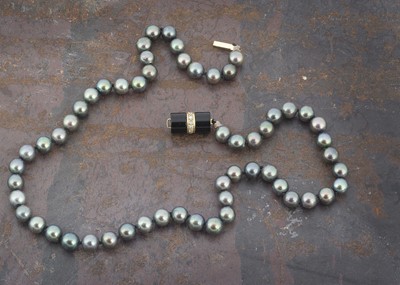 Lot 34 - A black cultured pearl uniform knotted strung necklace