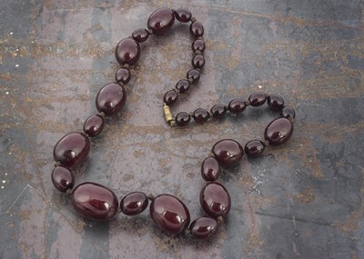 Lot 56 - A graduated oval string of 'cherry amber'