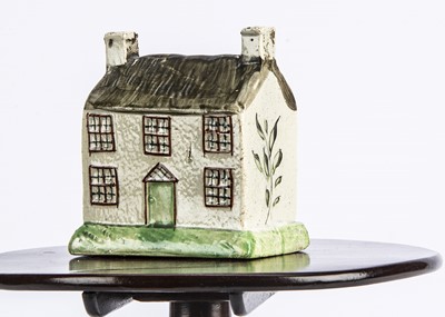 Lot 682 - A 19th century Staffordshire pearlware house money bank