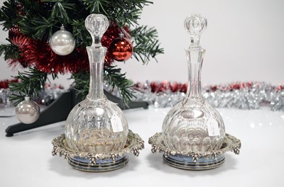 Lot 16 - A pair of Victorian silver plated wine bottle coasters by Elkington & Co with East Devonshire silver emblem to centres