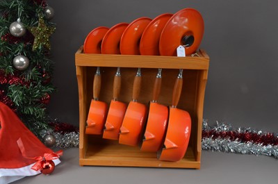 Lot 139 - A set of Le Cresuset graduated cast iron cooking pans and pine fitted rack hanging rack