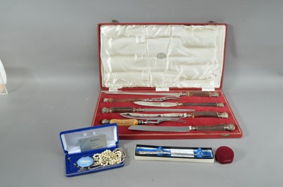 Lot 171 - A cased set of horn handled carving knives