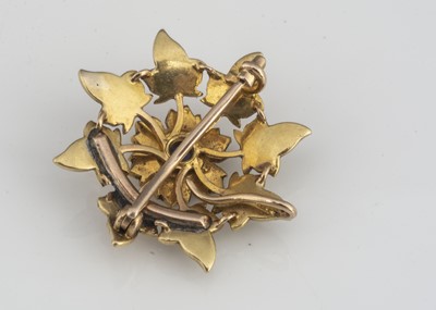 Lot 26 - A yellow metal seed pearl and sapphire flower brooch