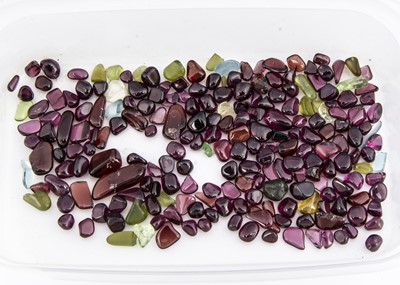 Lot 135 - A collection of polished garnet, quartz loose gems