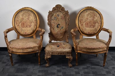 Lot 31 - A pair of French gilt upholstered armchairs