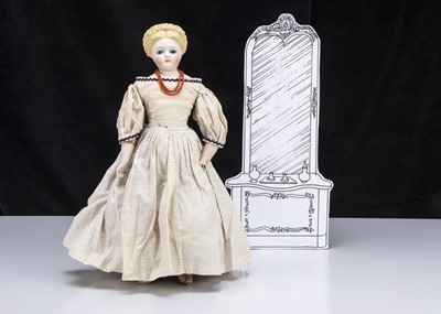 Lot 21 - A rare German bisque shoulder-head doll with glass eyes and elaborate hair