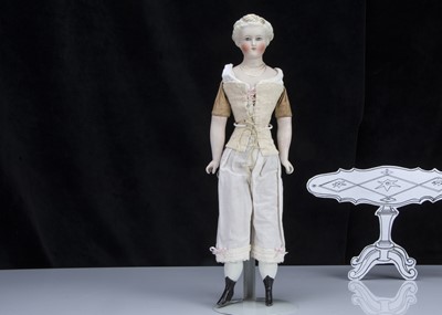 Lot 93 - A fine and rare German bisque shoulder-head doll with elaborate hair and moulded necklace