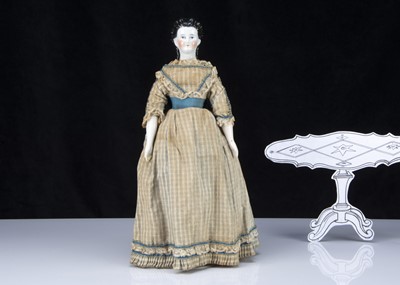 Lot 251 - A mid 19th century German china shoulder head doll with elaborate hair