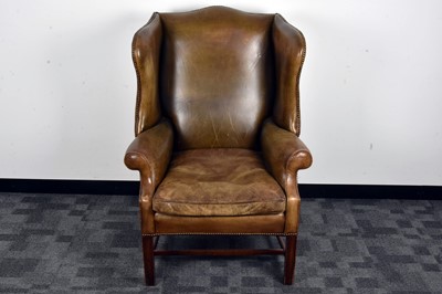 Lot 39 - A George III style leather wing back armchair
