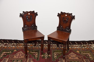 Lot 13 - A pair of Victorian carved mahogany hall chairs