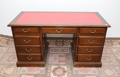 Lot 55 - A mid to late 20th century oak twin pedestal desk