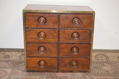 Lot 101 - An early 20th Century brass bound teak chest of drawers