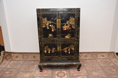 Lot 103 - A late 19th or early 20th century Japanese black lacquer and inlaid cabinet on stand