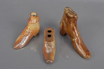 Lot 201 - A group of three 19th Century salt glazed treacleware shoe shape items
