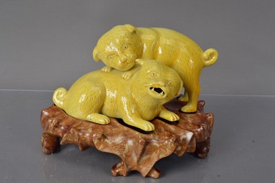 Lot 336 - A Chinese yellow glazed porcelain sculpture group of dogs playing