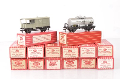 Lot 225 - 7 Hornby-Dublo 00 Gauge 2-Rail Super Detail 4657 'United Dairies' 6-wheel Milk Tank Wagons, various Oil Tank wagons and 4312 Guards Van (14)