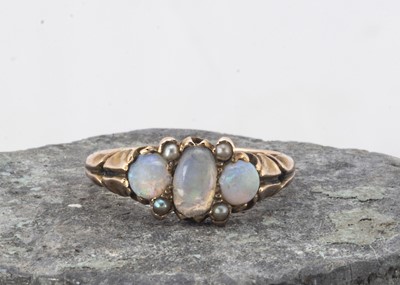 Lot 23 - An Edwadian three stone opal and seed pearl dress ring