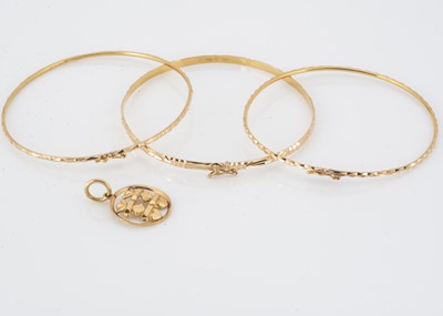 Lot 66 - Three continental yellow metal bangles