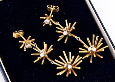Lot 104 - A pair of 18ct gold and diamond star burst earrings