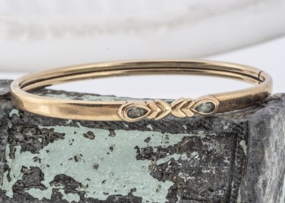 Lot 147 - A gem set hinged bangle