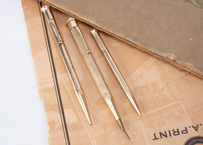 Lot 247 - Three first half 20th century 9ct gold propelling pencils
