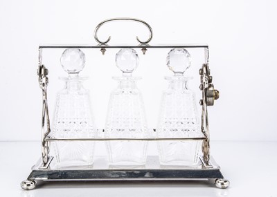 Lot 273 - An Edwardian period silver plated three decanter tantalis