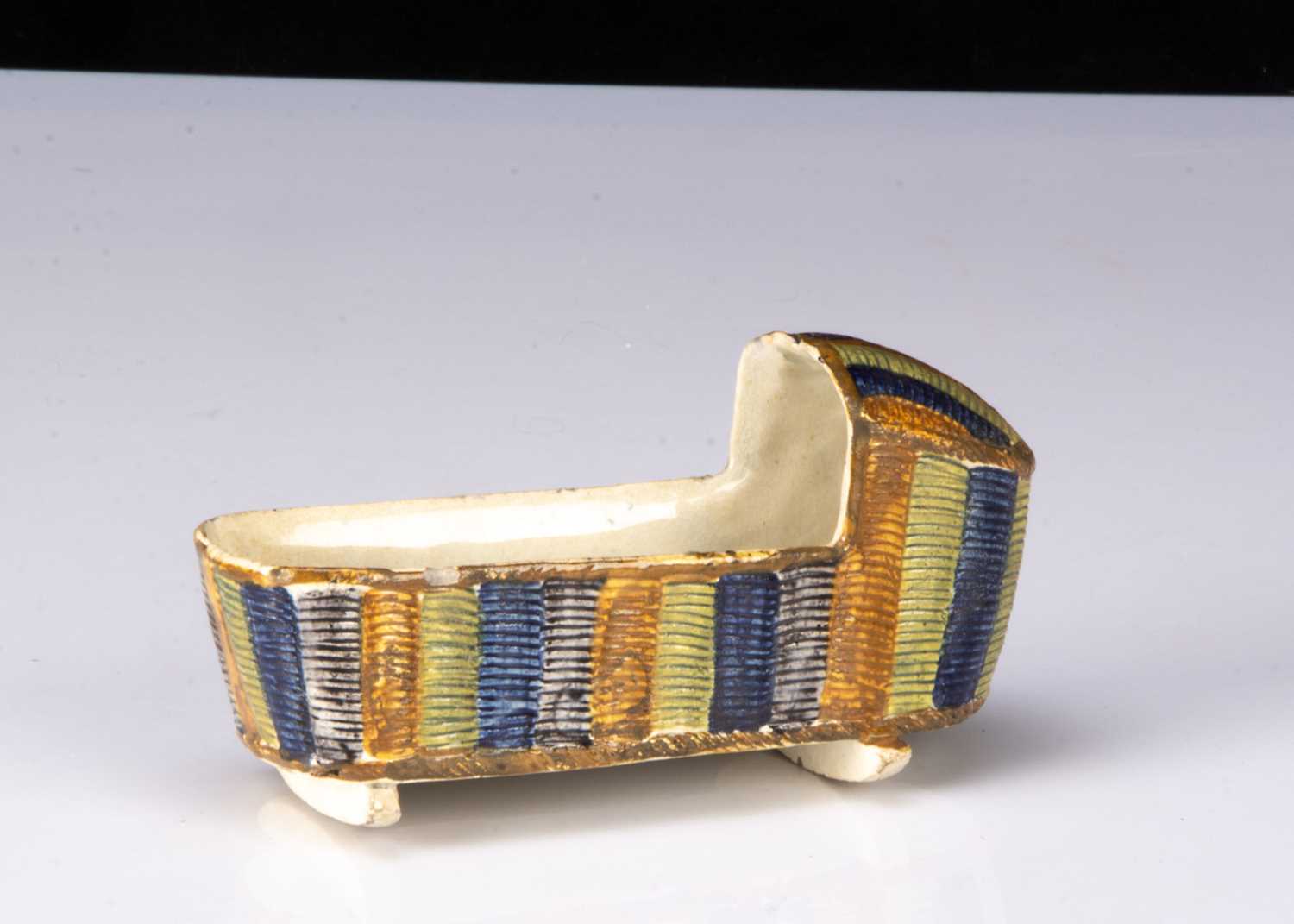 Lot 22 - A pearlware Pratt-type dolls’ house cradle, circa 1800