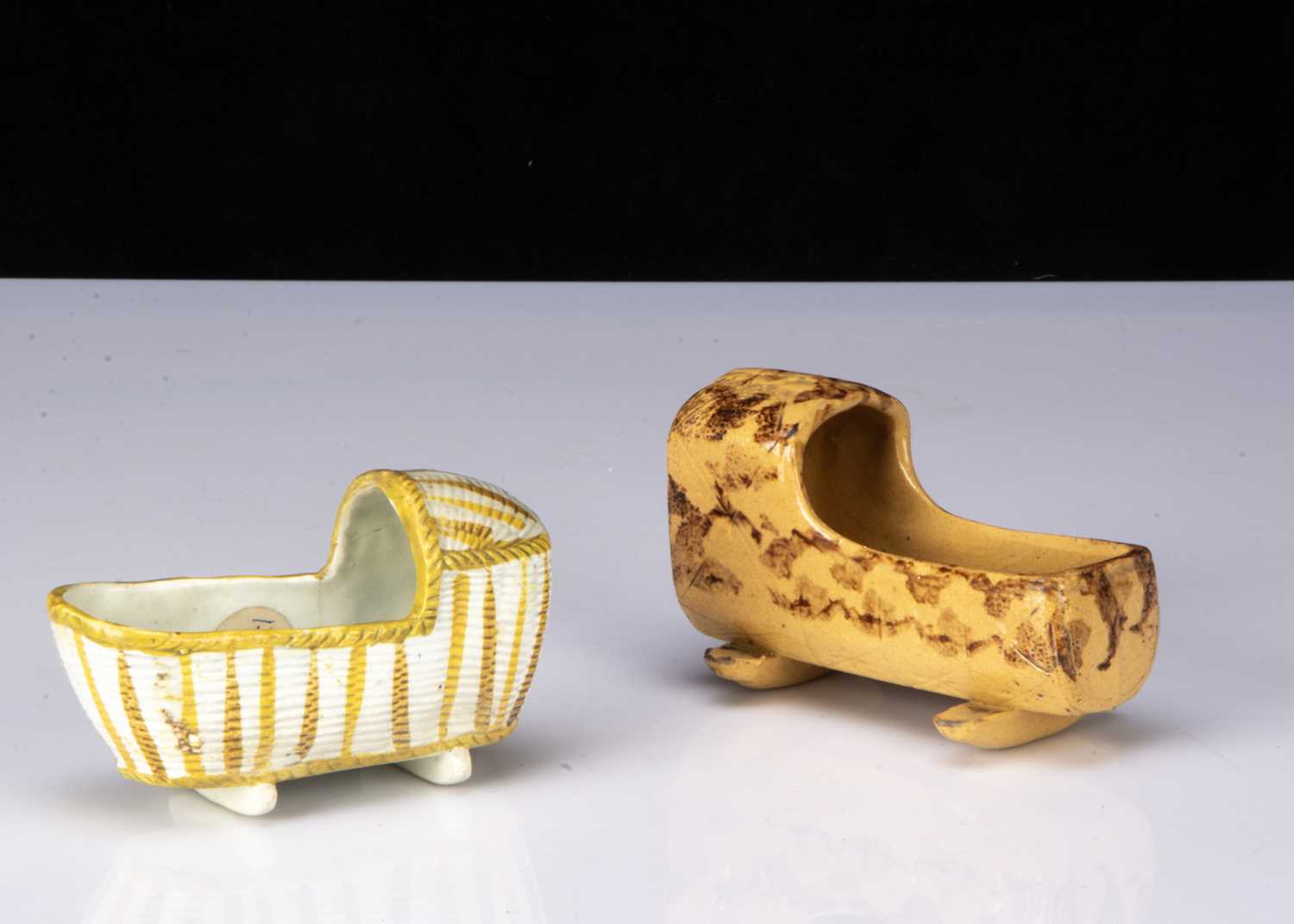 Lot 23 - A pearlware Pratt-type dolls’ house cradle, circa 1800