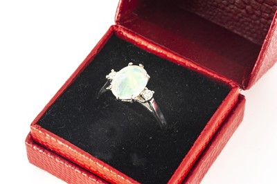 Lot 112 - An 18ct gold three stone opal and diamond dress ring