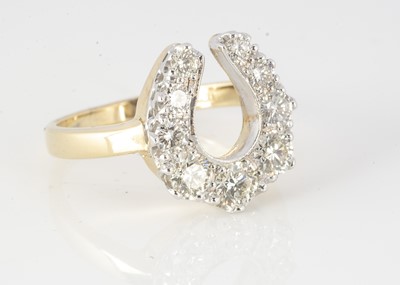Lot 153 - An 18ct yellow gold diamond horseshoe dress ring