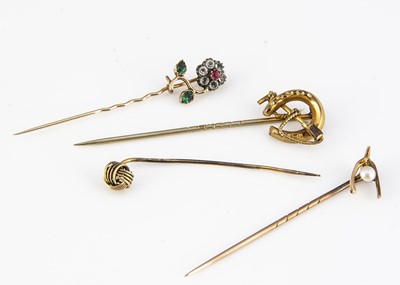 Lot 189 - A collection of four miscellaneous yellow metal stick pins