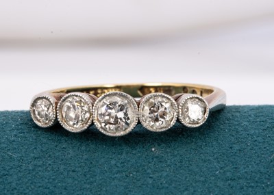 Lot 242 - An 18ct gold and platinum five stone diamond dress ring