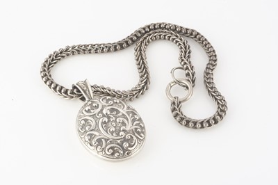 Lot 221 - A Victorian silver embossed oval locket